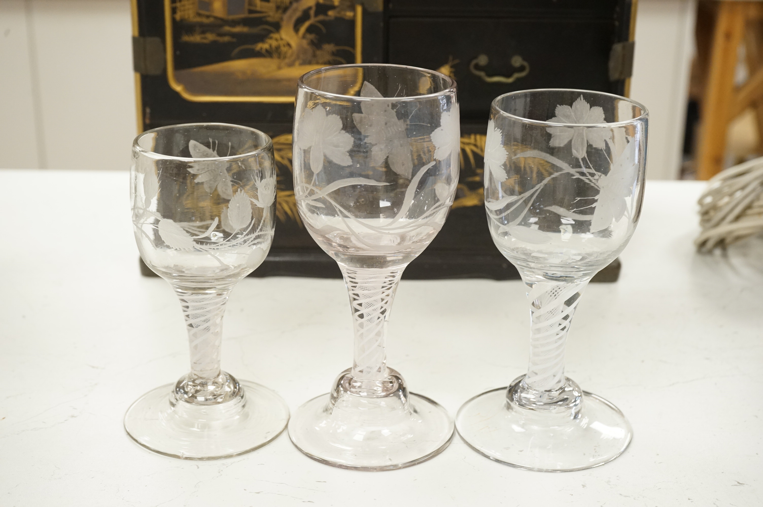 Three late 18th century Dutch DSOT stem goblets, each on a domed foot, engraved with a moth and flowers, 19.5cm and 18cm high
